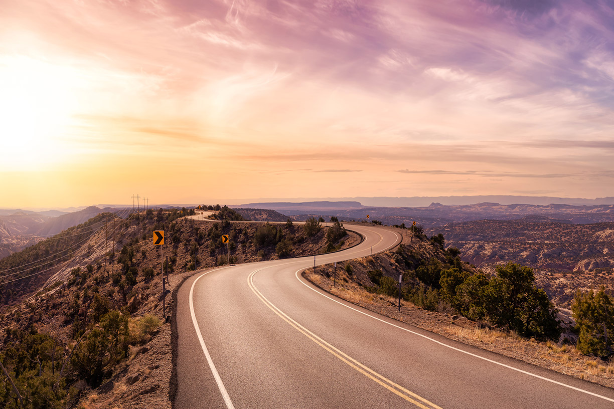 Winding road through the mountains at sunset