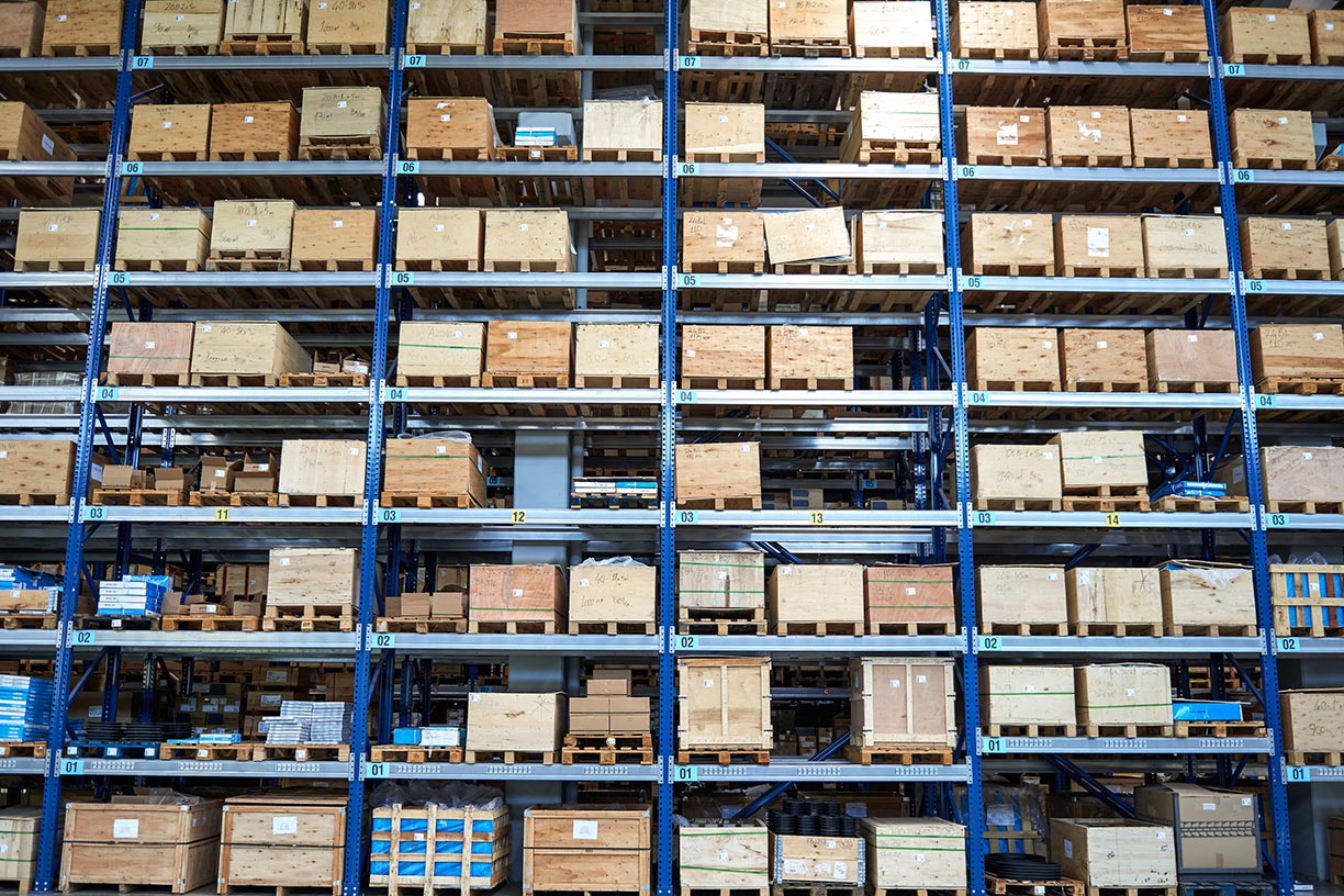 Warehouse shelves with boxes and wood pallets