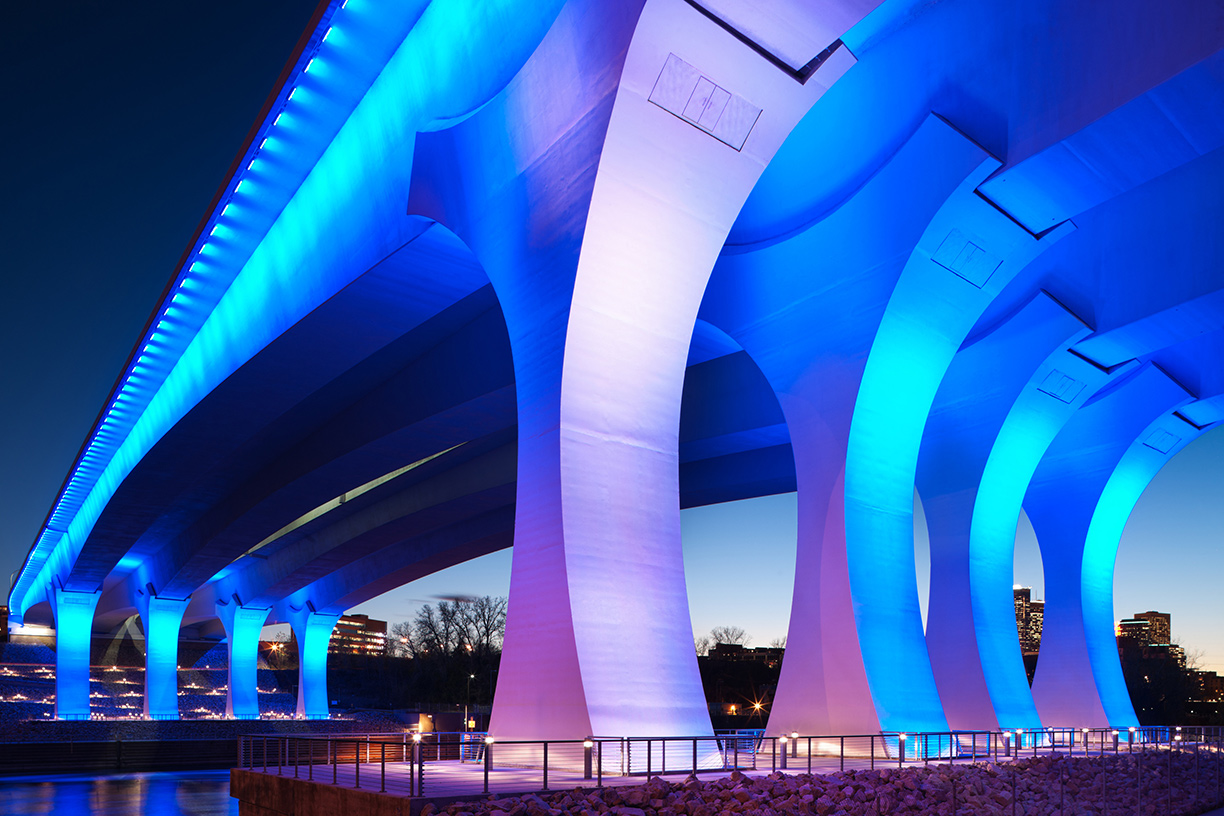 Colorful bridge lit up at night