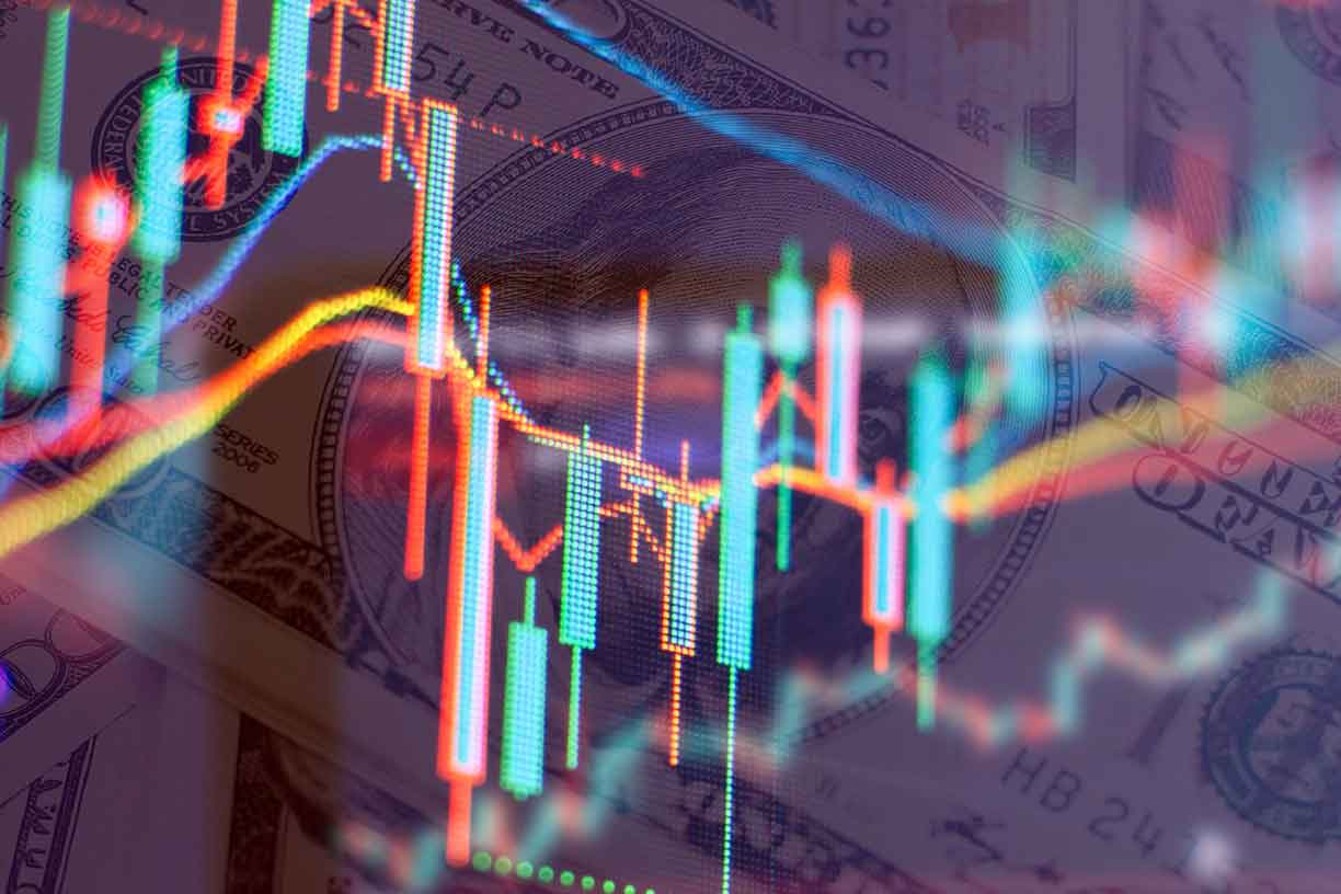 blue and orange bar chart superimposed over US 100 Dollar bills