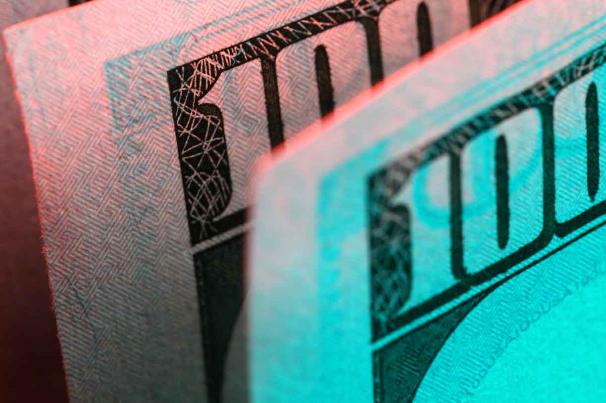 Hundred dollar bill in abstract lighting, close-up
