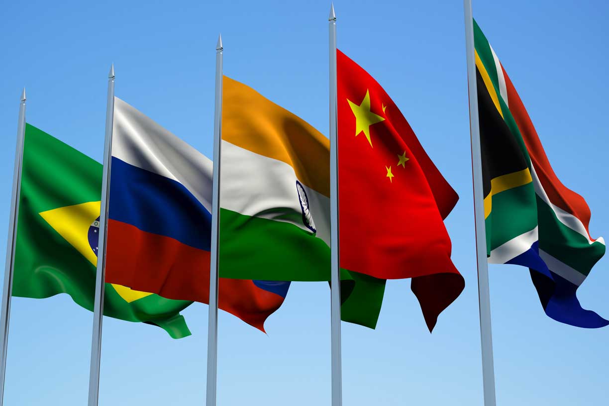 BRICS countries flags waving in the wind with a blue sky background. 3d illustration