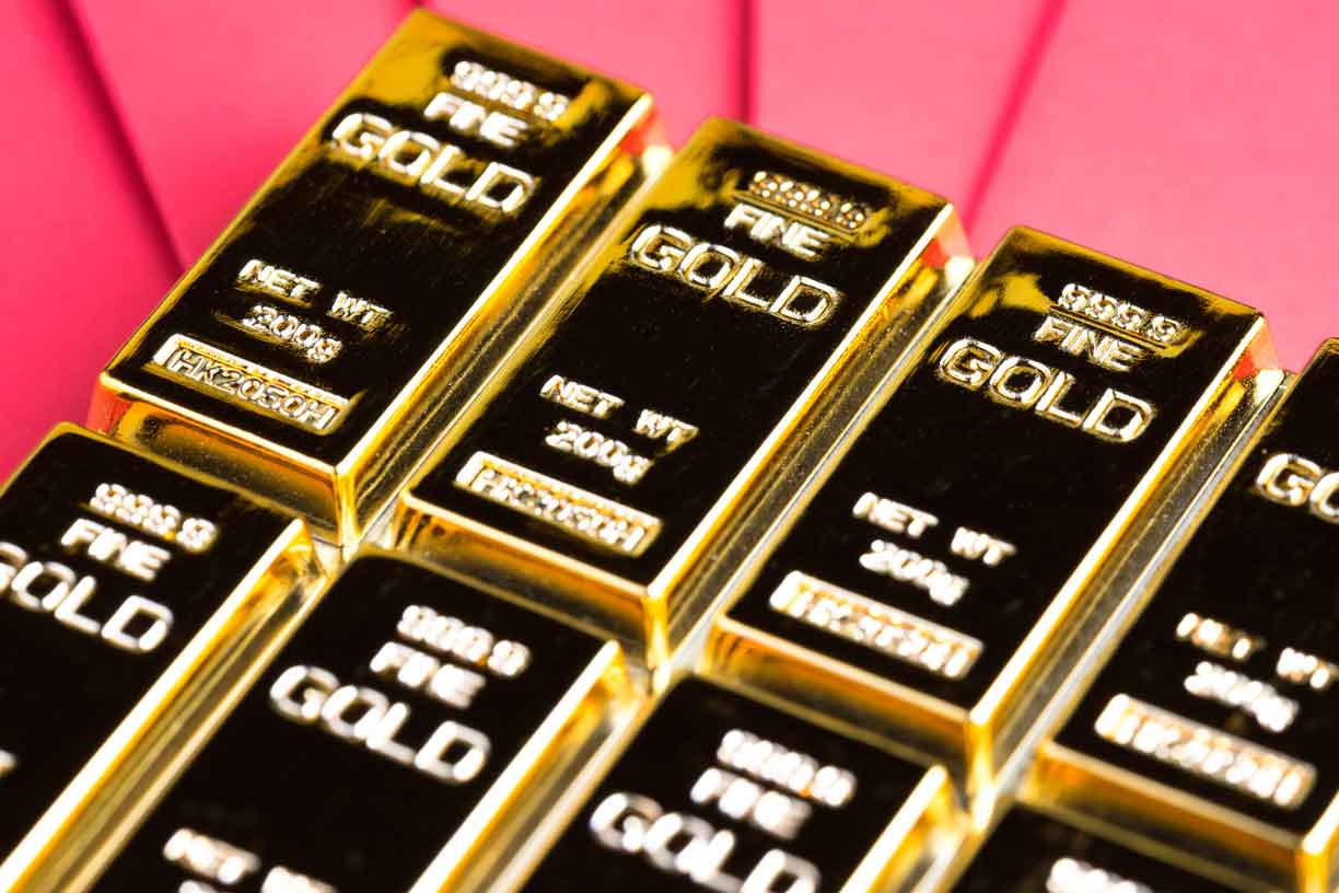 Gold bar, ingot or bullion on red envelope using as financial asset, saving or investment concept