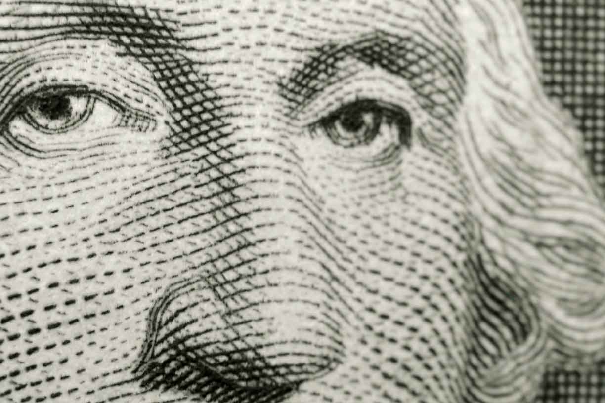Slightly off axis, shallow focus close up, of president George Washington, from obverse of American one dollar bill