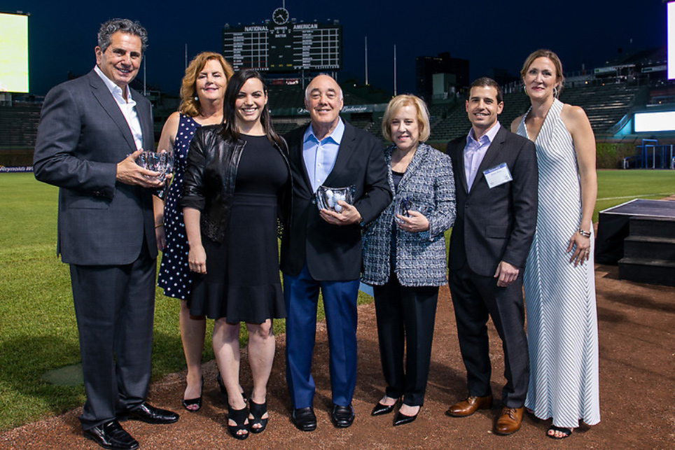 Group of people standing on baseball field