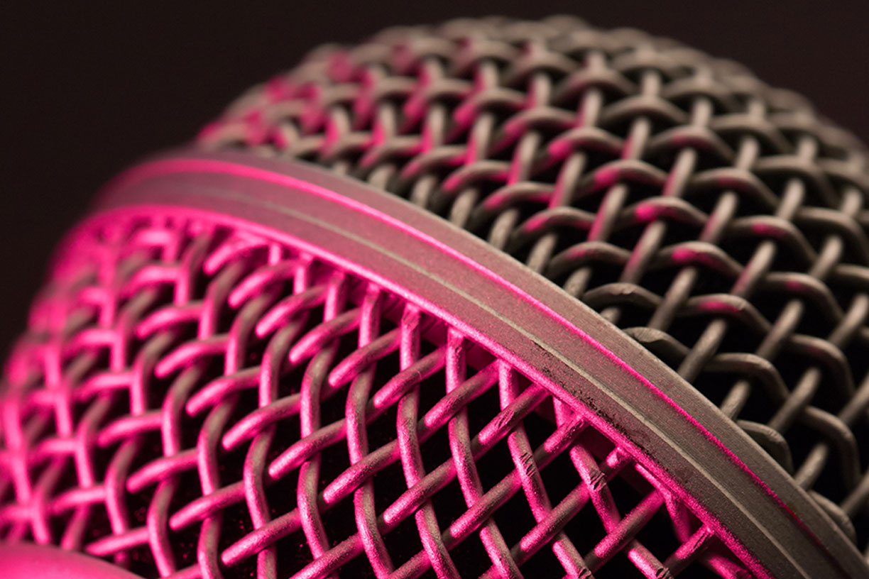 close-up of microphone texture in pink light