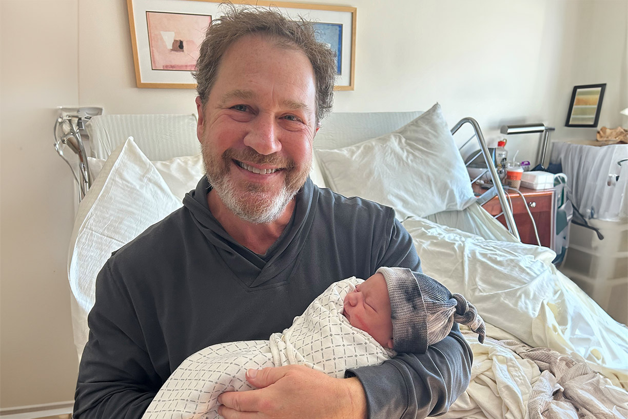 Lee Gordon holding his grandchild